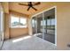 Enclosed lanai with tile flooring, ceiling fan and windows overlooking a scenic view at 2407 Kensington Greens Dr, Sun City Center, FL 33573