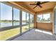 Enclosed lanai with tile flooring and multiple large windows with a view of the lake at 2407 Kensington Greens Dr, Sun City Center, FL 33573