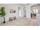 Open living space with neutral tile, stylish seating, and arched doorways at 2407 Kensington Greens Dr, Sun City Center, FL 33573