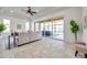 Open floor plan living room featuring large windows and seamless access to a sunroom at 2407 Kensington Greens Dr, Sun City Center, FL 33573