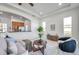 Bright and open living room featuring an archway to the modern kitchen at 2407 Kensington Greens Dr, Sun City Center, FL 33573