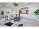 Open-concept living room with arched doorways and views into the adjacent kitchen area at 2407 Kensington Greens Dr, Sun City Center, FL 33573