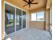 Bright sunroom featuring tiled floors and sliding glass doors offering views of a lush green landscape at 2407 Kensington Greens Dr, Sun City Center, FL 33573