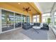 Inviting sunroom featuring tiled floors, a ceiling fan, and expansive sliding windows at 2407 Kensington Greens Dr, Sun City Center, FL 33573