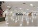 Spacious open auditorium with tiled floors, high ceilings, and stage offering flexible multi-purpose space at 2416 World Parkway Blvd # 26, Clearwater, FL 33763