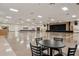 Expansive tiled-floor auditorium with stage, tables, chairs, and lots of open space for various activities at 2416 World Parkway Blvd # 26, Clearwater, FL 33763