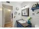 Cozy bathroom with stylish vanity and open doorway to other rooms at 2416 World Parkway Blvd # 26, Clearwater, FL 33763