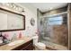 Updated bathroom with glass door shower, granite countertop and modern fixtures at 2416 World Parkway Blvd # 26, Clearwater, FL 33763