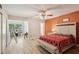Large bedroom featuring hard wood floors, bench and a view to the study room at 2416 World Parkway Blvd # 26, Clearwater, FL 33763