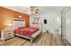 Bedroom featuring hard wood floors, ceiling fan and white colored furniture at 2416 World Parkway Blvd # 26, Clearwater, FL 33763
