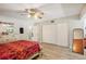 Spacious bedroom featuring hard wood floors, dresser and an open closet at 2416 World Parkway Blvd # 26, Clearwater, FL 33763