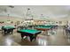 Large billiards room featuring multiple well-lit pool tables, creating an inviting recreational space at 2416 World Parkway Blvd # 26, Clearwater, FL 33763