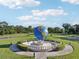 Beautiful community park area with a classic-style globe fountain surrounded by manicured landscaping at 2416 World Parkway Blvd # 26, Clearwater, FL 33763
