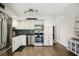 Bright kitchen with stainless steel appliances, white cabinetry and tile backsplash at 2416 World Parkway Blvd # 26, Clearwater, FL 33763