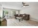 Cozy living room featuring a comfortable reclining sofa, fan, and a stylish coffee table at 2416 World Parkway Blvd # 26, Clearwater, FL 33763
