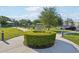 Scenic community park with paved walkways, lush greenery, and shaded picnic areas at 2416 World Parkway Blvd # 26, Clearwater, FL 33763