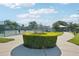 Scenic community park with a pickleball court, paved walkways, lush greenery, and shaded picnic areas at 2416 World Parkway Blvd # 26, Clearwater, FL 33763