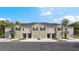A stunning exterior view of the townhome community with landscaping and individual garages at 259 Royal Spoonbill Dr, Ruskin, FL 33570