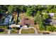 Wide aerial shot of the property displaying lush tree coverage, home, long drive and neighborhood setting with beautiful greenery at 26438 Glenwood Dr, Wesley Chapel, FL 33544