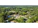 Panoramic aerial view showcases a property nestled among lush greenery with a long driveway and beautiful tree coverage at 26438 Glenwood Dr, Wesley Chapel, FL 33544