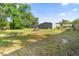 Expansive backyard with ample green space, mature trees, and a fenced perimeter at 26438 Glenwood Dr, Wesley Chapel, FL 33544