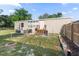 Backyard with grassy area, seating, grill, and fencing at 26438 Glenwood Dr, Wesley Chapel, FL 33544