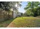 Spacious backyard featuring a lush lawn and mature trees, perfect for outdoor activities at 26438 Glenwood Dr, Wesley Chapel, FL 33544