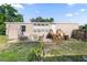 Grassy backyard with an outdoor seating area, grill, and a small wooden deck at 26438 Glenwood Dr, Wesley Chapel, FL 33544