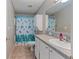 Functional bathroom with a vanity, toilet, and shower with a turtle-themed curtain at 26438 Glenwood Dr, Wesley Chapel, FL 33544