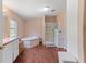 Bright bathroom featuring a soaking tub, separate shower, and neutral decor at 26438 Glenwood Dr, Wesley Chapel, FL 33544