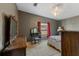 Bedroom with neutral carpet, a large window, and dark gray accent wall at 26438 Glenwood Dr, Wesley Chapel, FL 33544