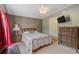 Comfortable bedroom featuring vintage wood furniture and red curtains at 26438 Glenwood Dr, Wesley Chapel, FL 33544