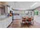 Well-equipped kitchen with white cabinets, stainless steel appliances, and a cozy island with seating at 26438 Glenwood Dr, Wesley Chapel, FL 33544