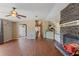 Inviting living room featuring hardwood floors, a stone fireplace, and an open layout at 26438 Glenwood Dr, Wesley Chapel, FL 33544