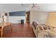 Inviting living room showcasing hardwood floors, cozy seating, and neutral paint at 26438 Glenwood Dr, Wesley Chapel, FL 33544