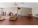Spacious living room featuring a ceiling fan, wood floors, and neutral-colored walls at 26438 Glenwood Dr, Wesley Chapel, FL 33544