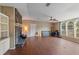 Bright living room with hardwood floors, a stone fireplace, and large windows that let in natural light at 26438 Glenwood Dr, Wesley Chapel, FL 33544