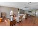Open-concept living room with wood floors, comfortable seating, and a view into another room at 26438 Glenwood Dr, Wesley Chapel, FL 33544