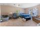 Comfortable main bedroom with neutral carpet, a cozy chair, and a large bed at 26438 Glenwood Dr, Wesley Chapel, FL 33544