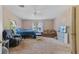 Open main bedroom with a ceiling fan, carpet, and large windows for plenty of natural light at 26438 Glenwood Dr, Wesley Chapel, FL 33544