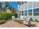 Back patio with comfortable seating and lush tropical foliage at 2903 Pass A Grille Way, St Pete Beach, FL 33706