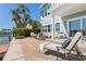 Outdoor space with comfortable seating, lush greenery, and scenic water views at 2903 Pass A Grille Way, St Pete Beach, FL 33706
