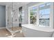 Modern bathroom featuring a freestanding tub and a glass-enclosed shower with updated fixtures at 2903 Pass A Grille Way, St Pete Beach, FL 33706