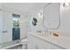 Bright bathroom featuring a walk-in shower with glass door, updated fixtures, and custom decor at 2903 Pass A Grille Way, St Pete Beach, FL 33706