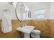 Bright bathroom with a pedestal sink, unique tile, and a window providing natural light at 2903 Pass A Grille Way, St Pete Beach, FL 33706