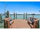 A relaxing boat dock features bench seating with blue pillows and a view of the water at 2903 Pass A Grille Way, St Pete Beach, FL 33706