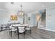 Dining room with stairs, abstract art, modern lighting fixture, and seating for six at 2903 Pass A Grille Way, St Pete Beach, FL 33706