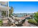 Serene outdoor patio with comfortable seating, a brick surface, and picturesque waterfront views with a private dock at 2903 Pass A Grille Way, St Pete Beach, FL 33706