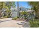 Charming two-story home with a well-manicured lawn, lush landscaping, and a welcoming front entrance at 2903 Pass A Grille Way, St Pete Beach, FL 33706