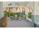 Inviting front porch with comfortable seating and decorative accents at 2903 Pass A Grille Way, St Pete Beach, FL 33706